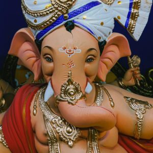 Intricate close-up of a traditional Lord Ganesha sculpture adorned with gold, captured in Mumbai.